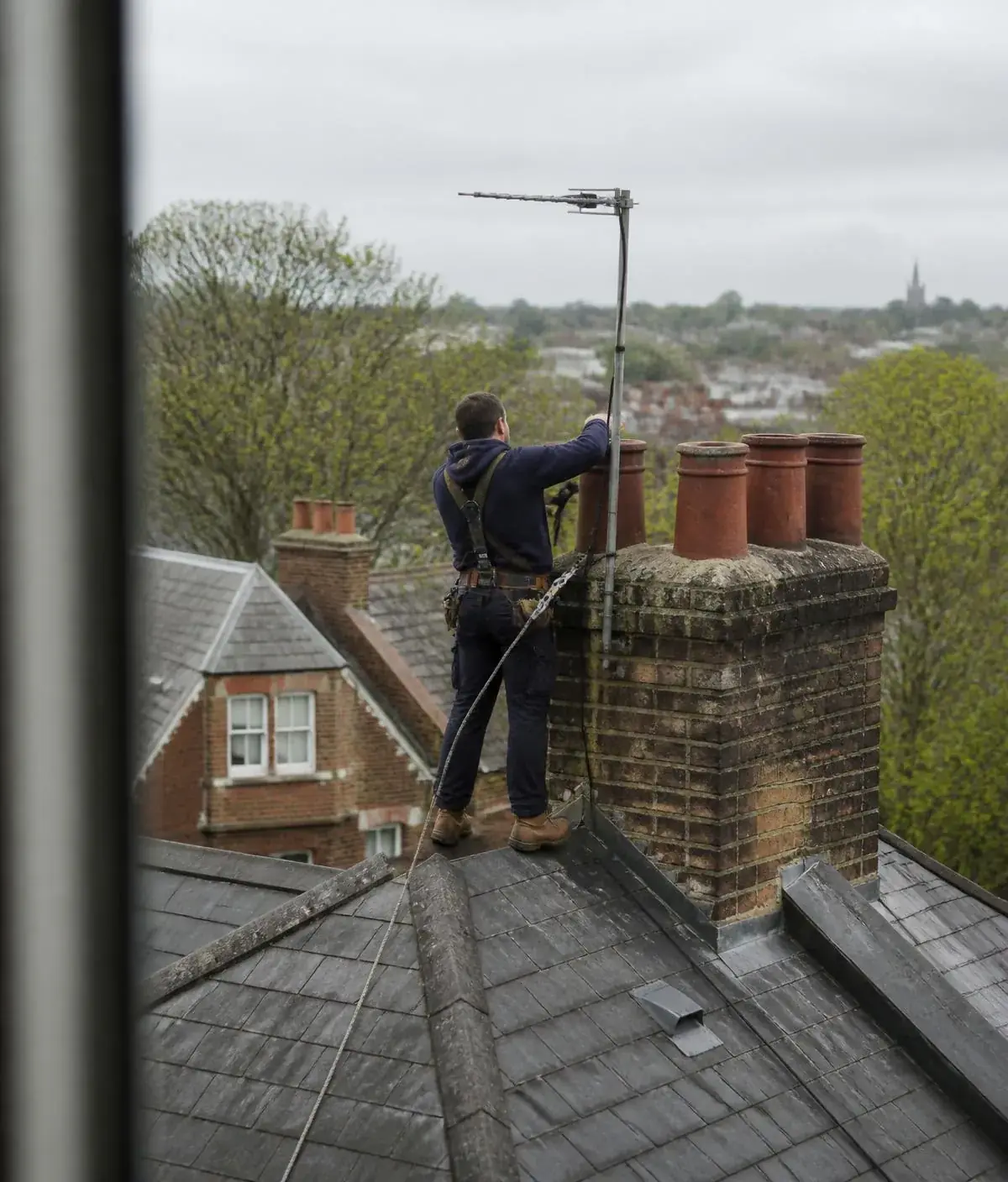 Hampstead Aerials engineers fitting a digital TV aerial to a chimney stack on a North London roof
